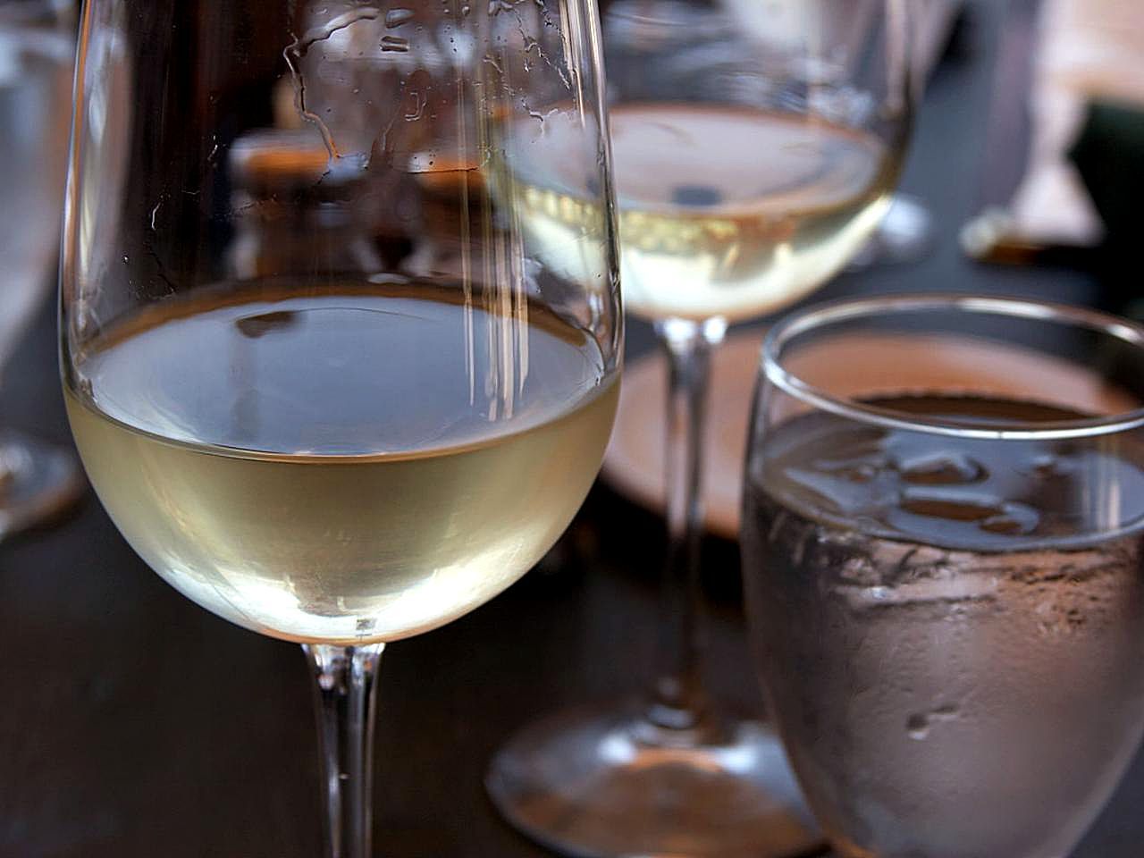 Čaša belog vina — suva malvazija u čaši otkriva bledožutu boju sa zelenkastim tonovima